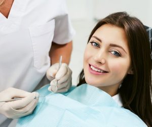 Dentist,Examining,A,Patient's,Teeth,In,Modern,Dentistry,Office.,Closeup